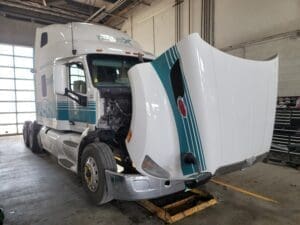 White TransX semi with hood open
